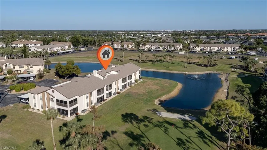 Aerial view of property's location featuring a large body of water and nearby suburban area