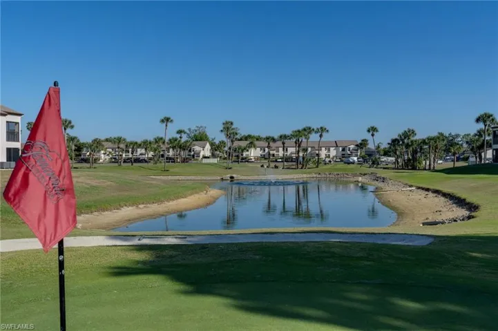 View of community featuring a yard, a water view, and a residential view