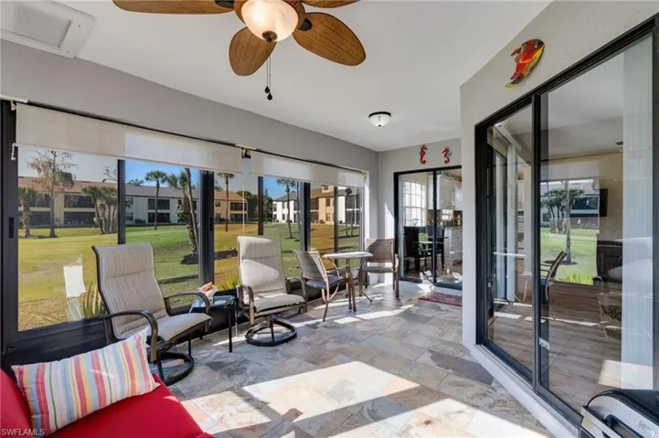 Sunroom / solarium featuring stone tile floors