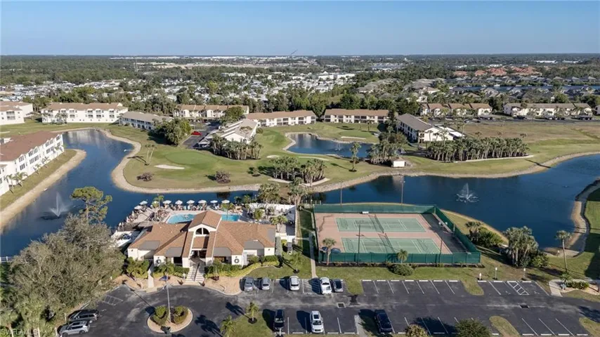 Aerial view of property and surrounding area with a large body of water and a local golf course