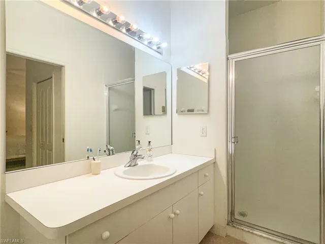 Bathroom featuring vanity and a shower with shower door