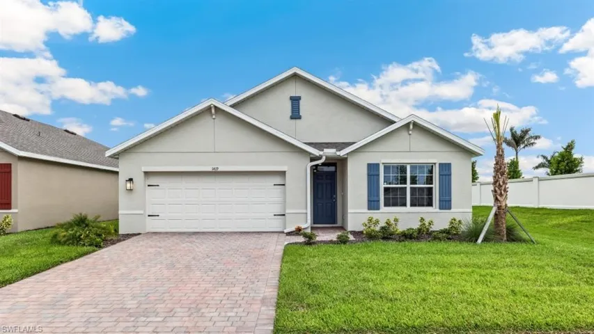 Model home. Ranch-style home featuring stucco siding, decorative driveway, and a garage