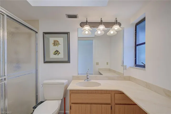 Full bathroom featuring vanity and a shower stall
