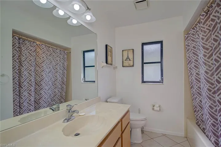 Full bathroom featuring vanity, tile patterned floors, and shower / bath combo