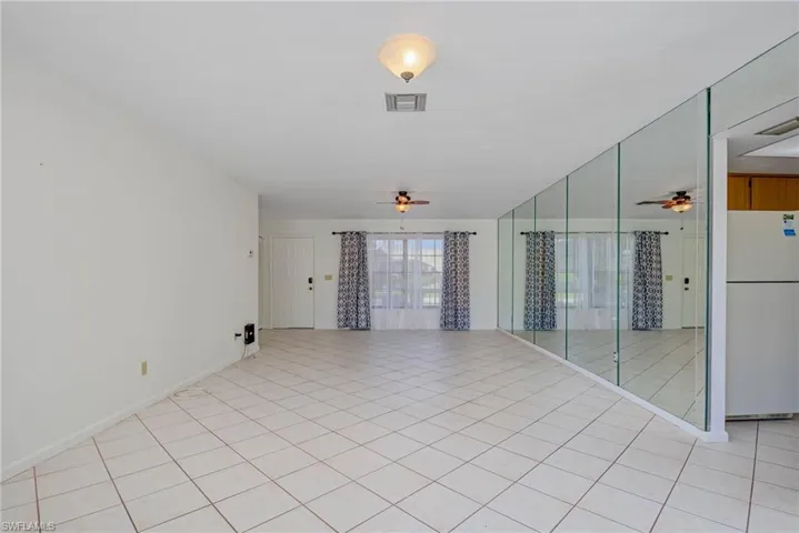 Spare room featuring a ceiling fan and light tile patterned floors