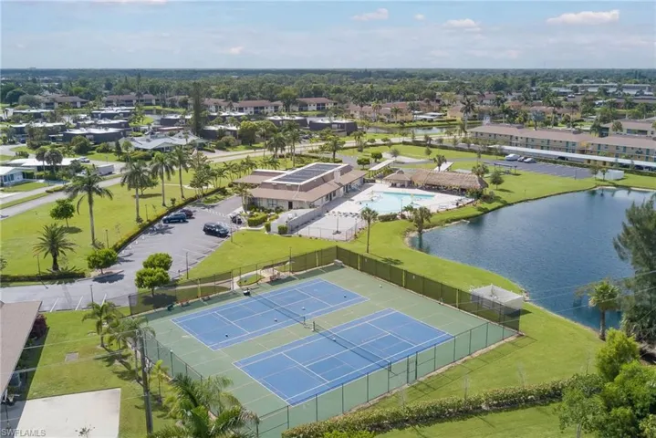 Drone / aerial view of tennis courts andnearby body of water