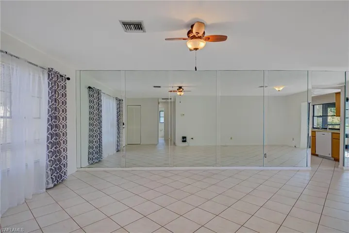 Unfurnished room featuring a ceiling fan and light tile patterned flooring