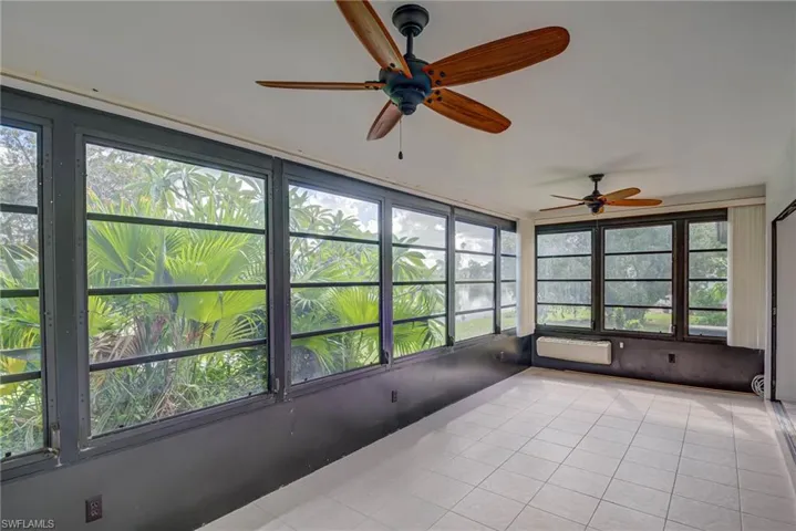 Unfurnished sunroom with tile patterned flooring