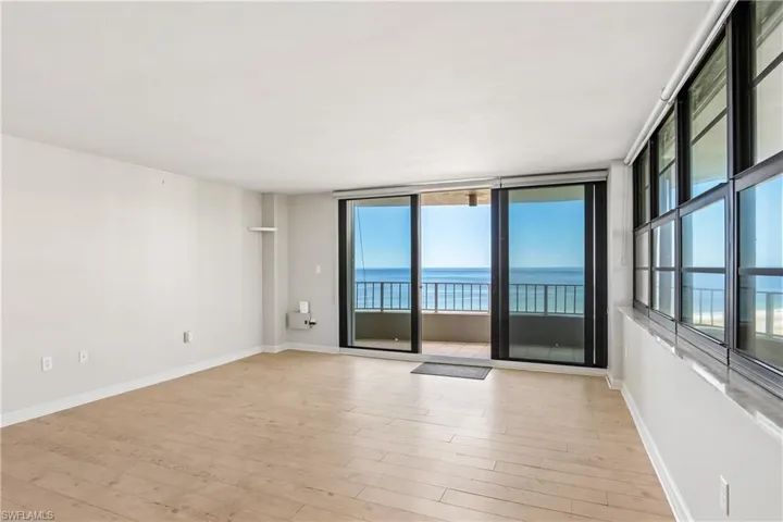 Living Room with Sliders out to the Beachfront and windows.