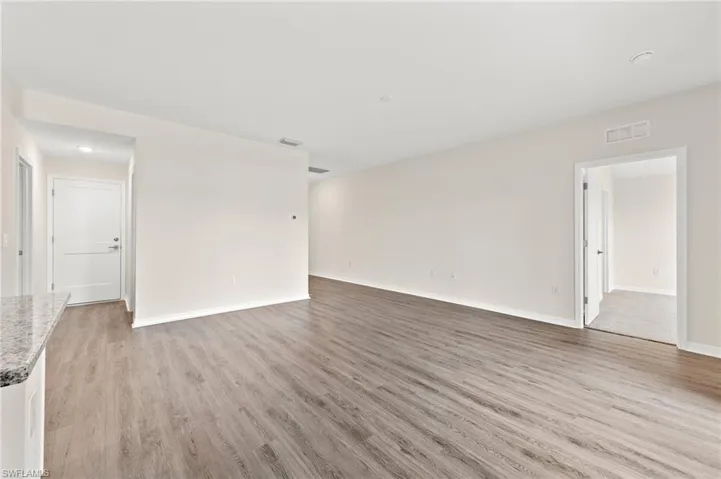 Unfurnished room with light wood-style flooring and baseboards