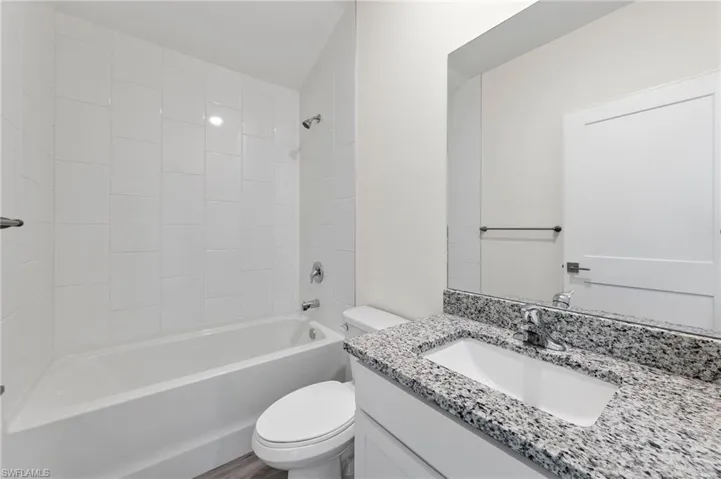 Bathroom featuring bathtub / shower combination and vanity