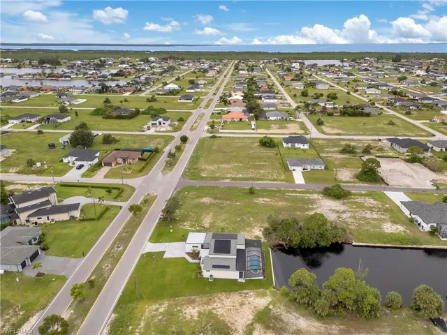 Aerial overview of property's location with a nearby body of water and nearby suburban area