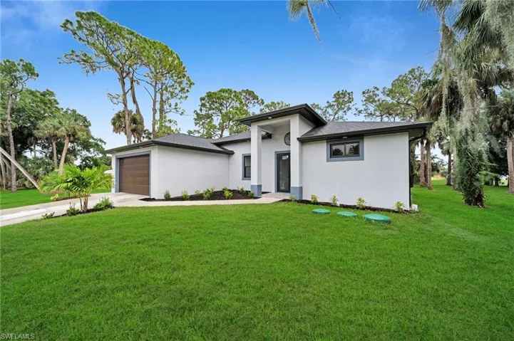 View of front facade with a garage and a front yard