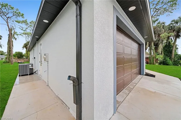 View of property exterior featuring cooling unit and a yard