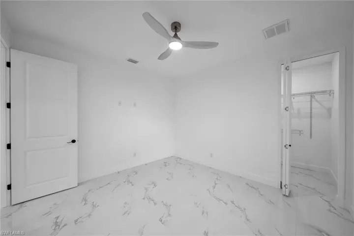 Unfurnished bedroom featuring ceiling fan and a closet