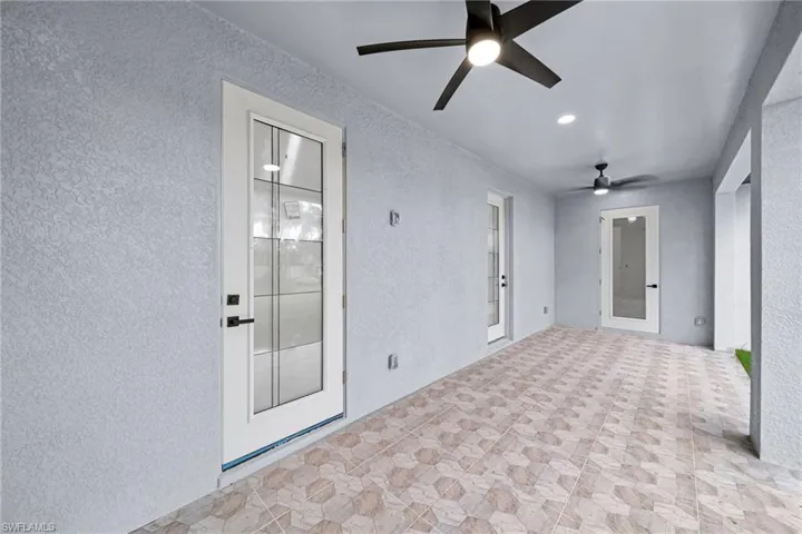 Unfurnished sunroom featuring ceiling fan