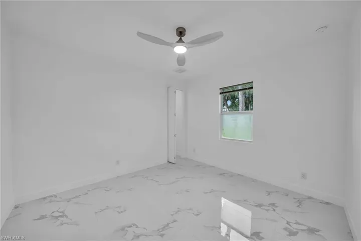 Empty room featuring ceiling fan