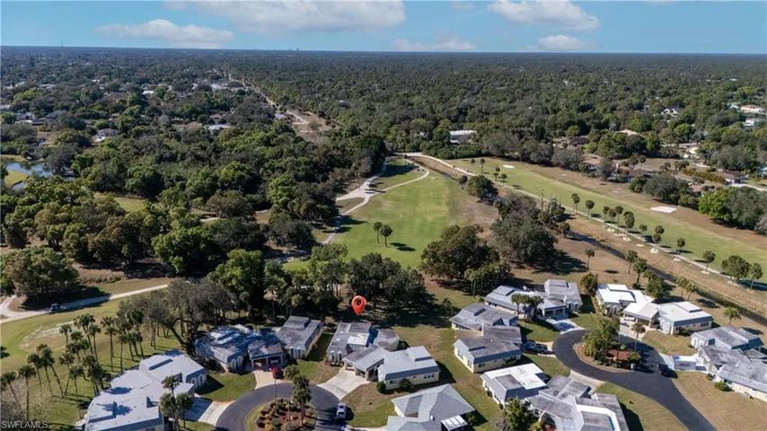 Aerial overview of property's location featuring nearby suburban area and a golf club