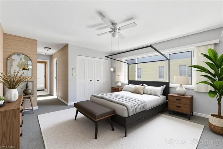Carpeted bedroom with a closet and a ceiling fan - Viturally staged