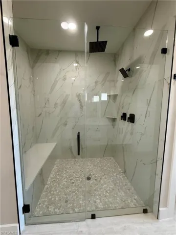 Bathroom featuring a marble finish shower