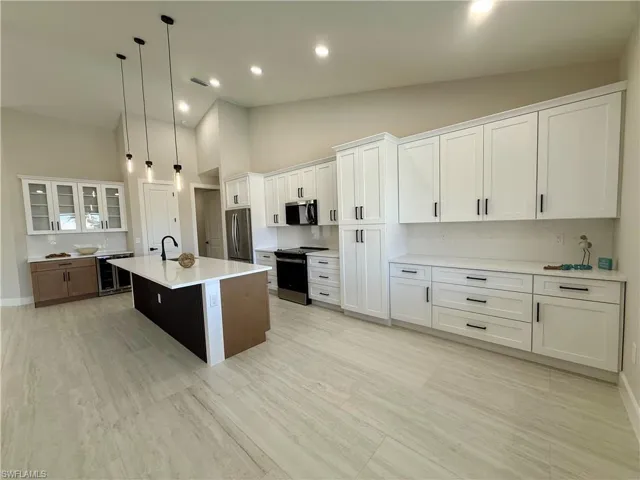 Dining area featuring vaulted ceiling, light wood-style flooring, and recessed lighting