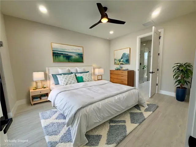 Bedroom featuring light wood finished floors, ceiling fan, and recessed lighting