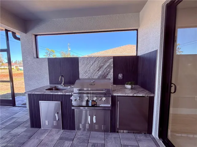 View of patio / terrace featuring area for grilling and a sink