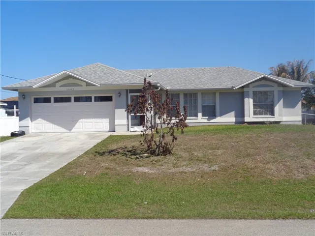 Front view of single story house with a garage and paved driveway.