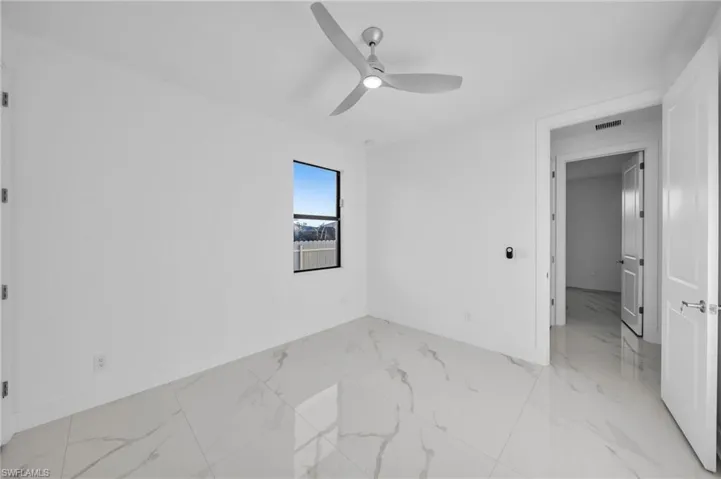 Unfurnished bedroom featuring visible vents, baseboards, and marble finish floor