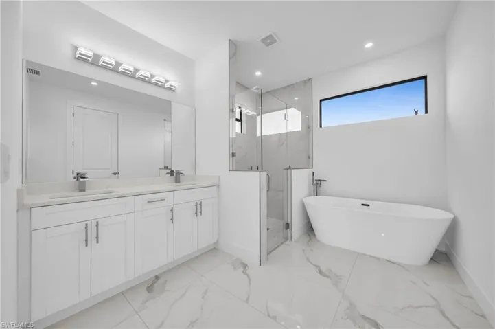 Bathroom featuring a sink, visible vents, a marble finish shower, and marble finish floor