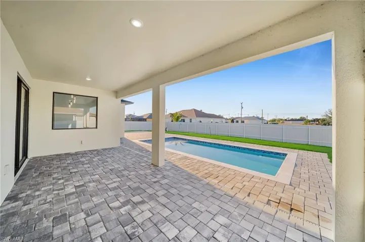 View of swimming pool with a patio area, a fenced in pool, and a fenced backyard