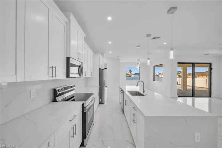 Kitchen featuring visible vents, recessed lighting, a sink, appliances with stainless steel finishes, and marble finish floor