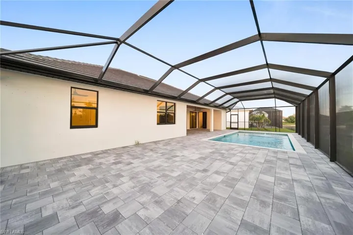 Outdoor pool featuring a sunroom, a lanai, and a patio area