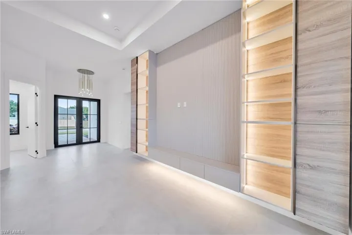 Spare room featuring french doors, a high ceiling, and recessed lighting