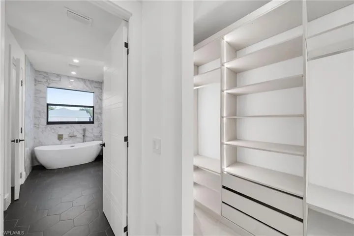 Walk in closet with tile patterned floors