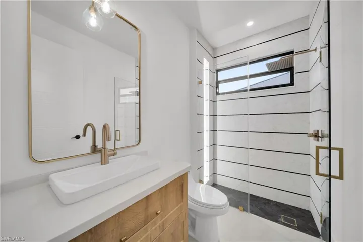 Bathroom featuring vanity and a stall shower