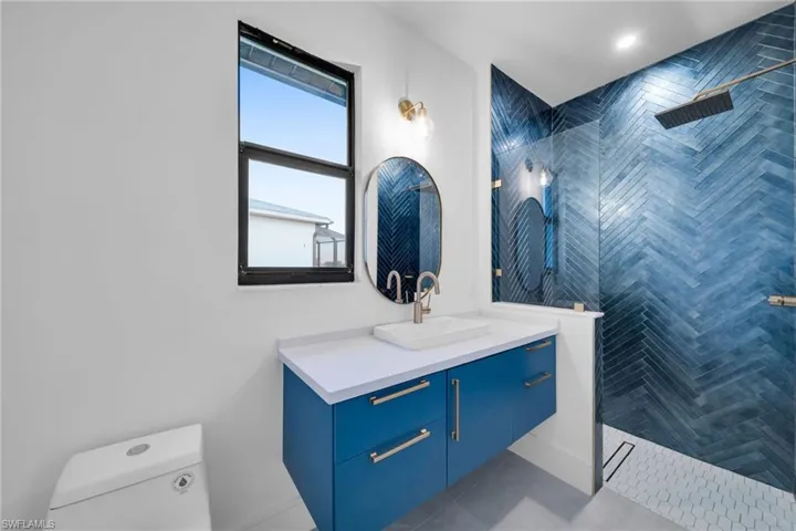 Full bathroom featuring vanity, walk in shower, and tile patterned floors