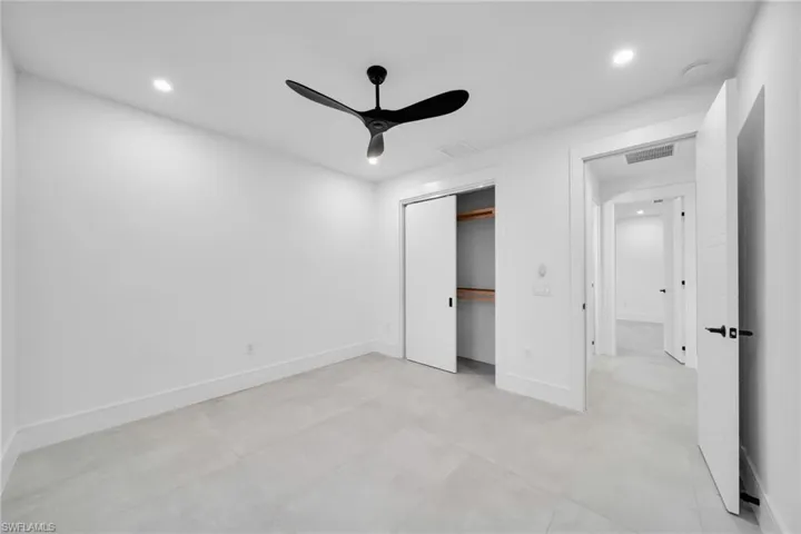 Unfurnished bedroom with a ceiling fan, recessed lighting, and a closet