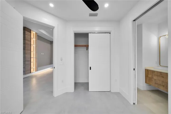 Unfurnished bedroom featuring concrete floors, recessed lighting, a closet, and ceiling fan