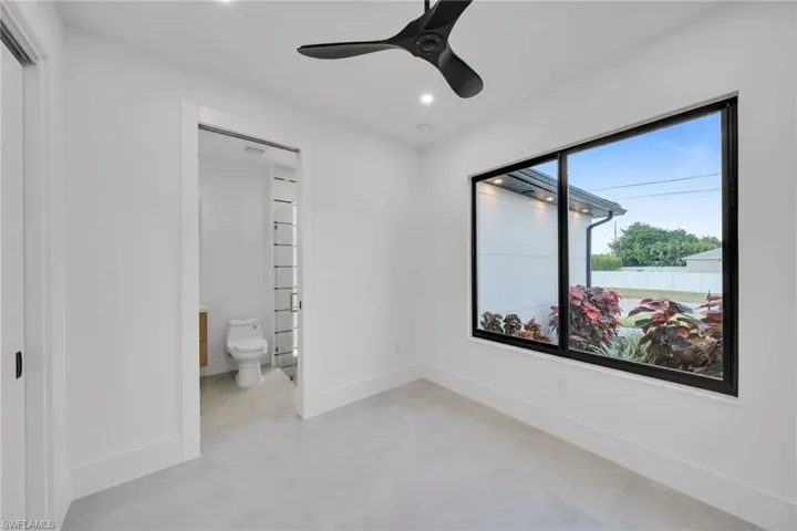 Unfurnished bedroom with a ceiling fan, recessed lighting, and connected bathroom