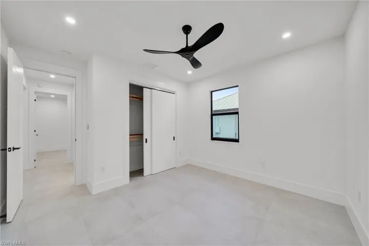 Unfurnished bedroom featuring ceiling fan, recessed lighting, and a closet