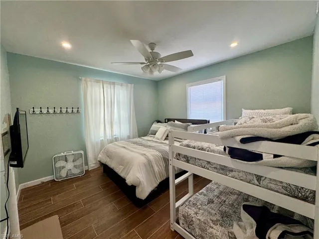 Bedroom featuring ceiling fan and dark hardwood / wood-style flooring