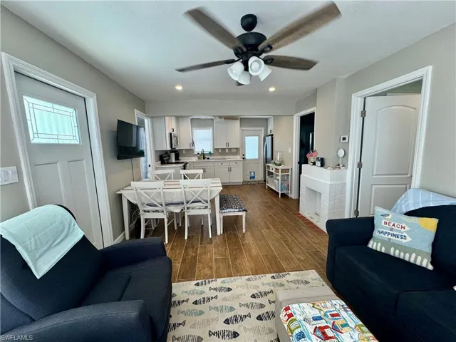 Living room with sink, wood-type flooring, and ceiling fan
