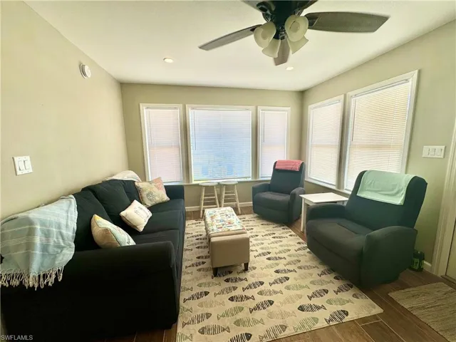 Living room featuring ceiling fan and wood-type flooring