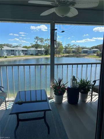 Balcony with a ceiling fan and a water view