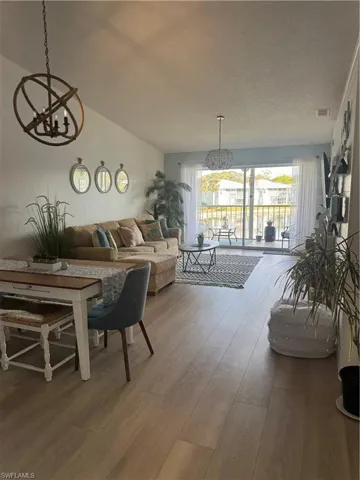 Living area featuring a chandelier and light wood-style floors