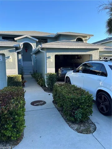 View of home's exterior with stucco siding and a garage