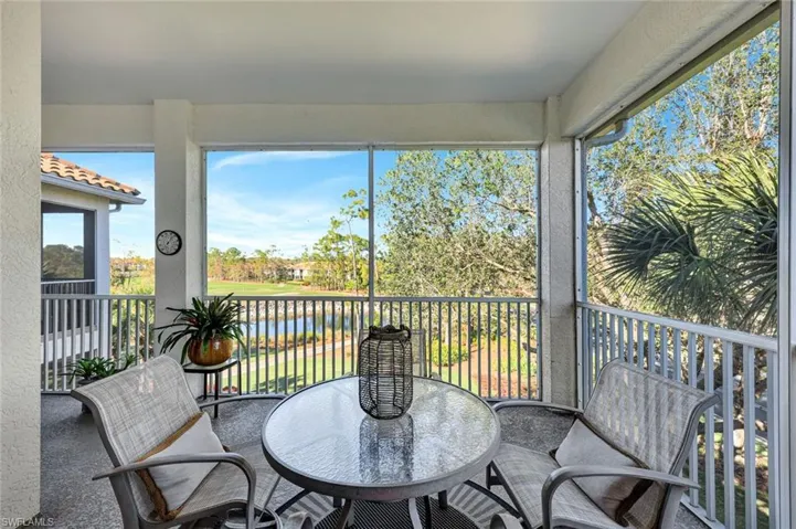 Sunroom / solarium featuring a water view