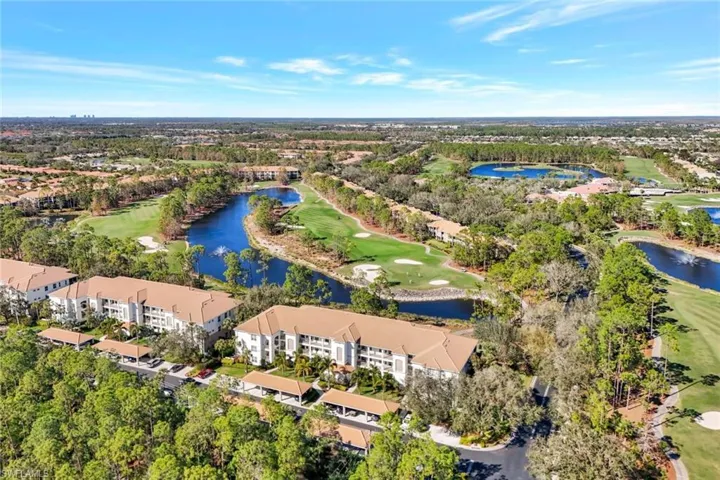 Aerial view showing Waterford condo building with golf and water views