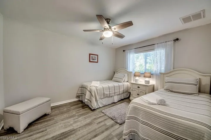 Bedroom with hardwood / wood-style floors and ceiling fan